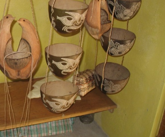 Woven baskets, carved calabash bowls and coconut-shell ornaments in a Kalinago craft shop