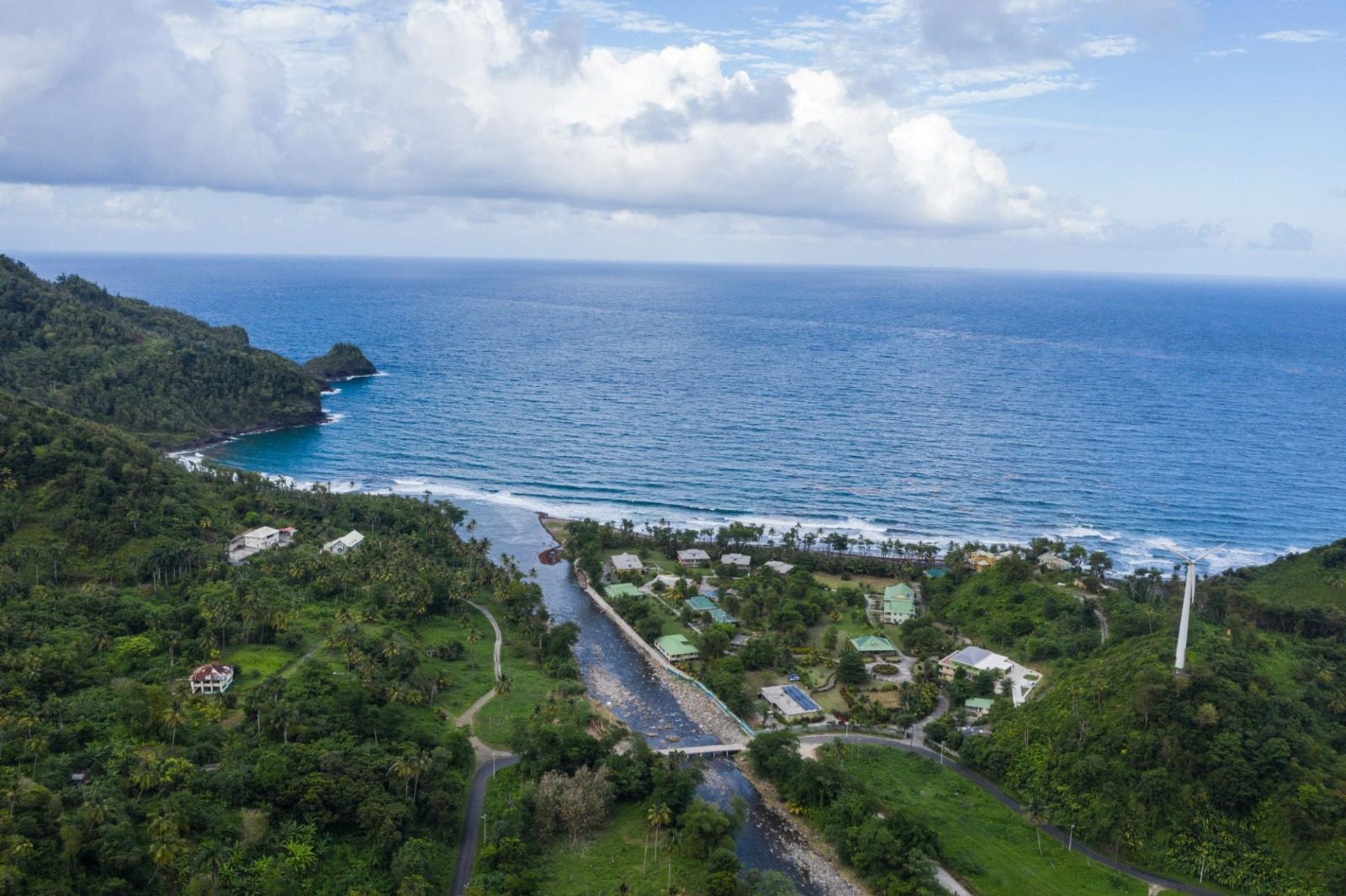 Aerial view of Dominica's coastline where a river meets the Atlantic