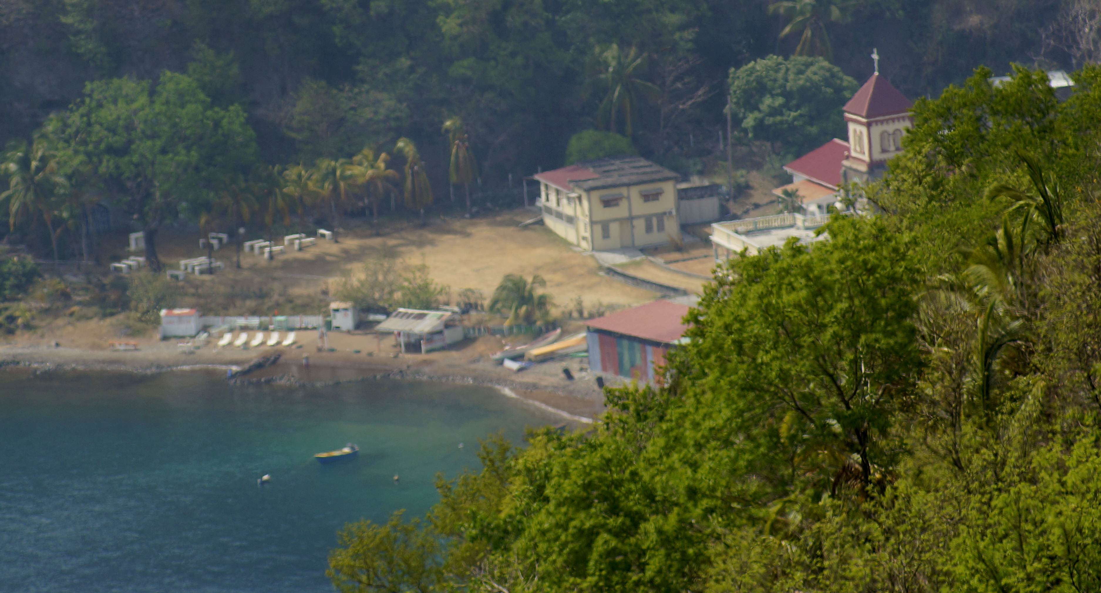 Aerial view of Dominica's southwest coast with Soufrière village nestled between the sea and forested hills