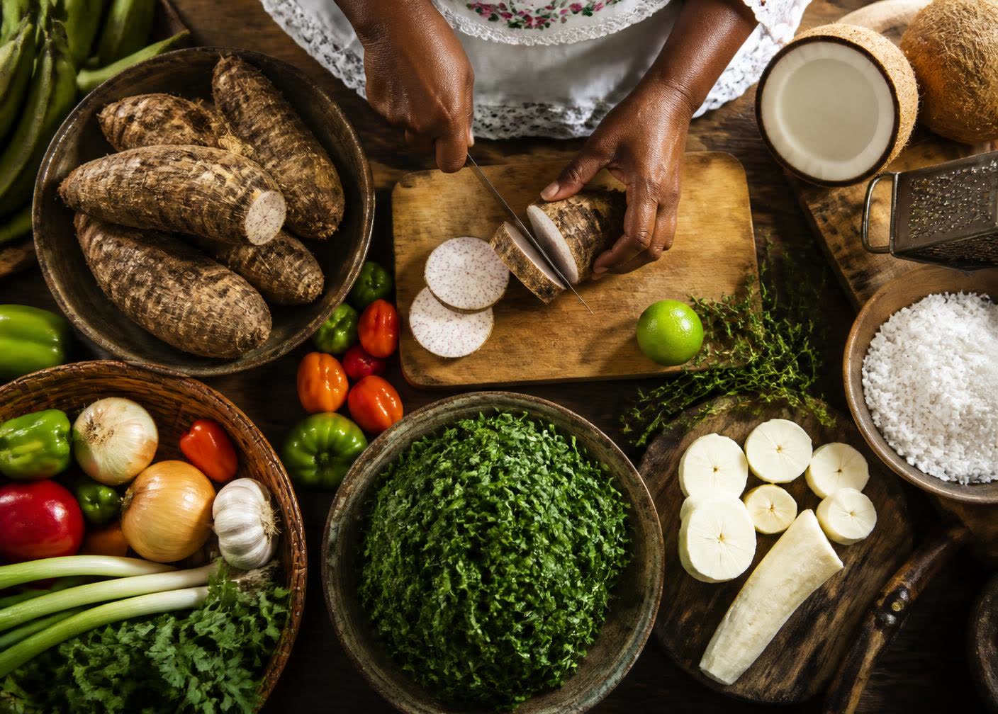 Hands preparing traditional Creole ingredients