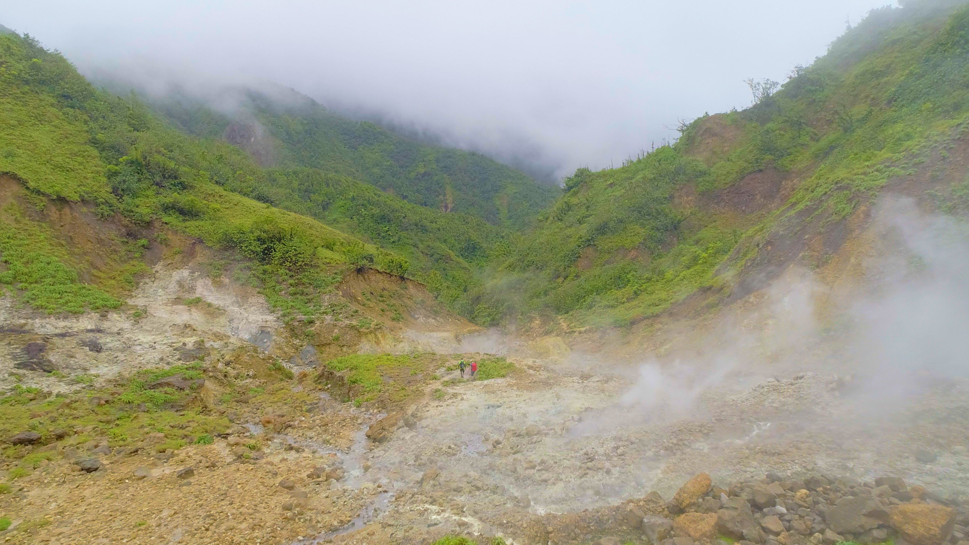 The Valley of Desolation with sulphur vents and mineral-stained ground